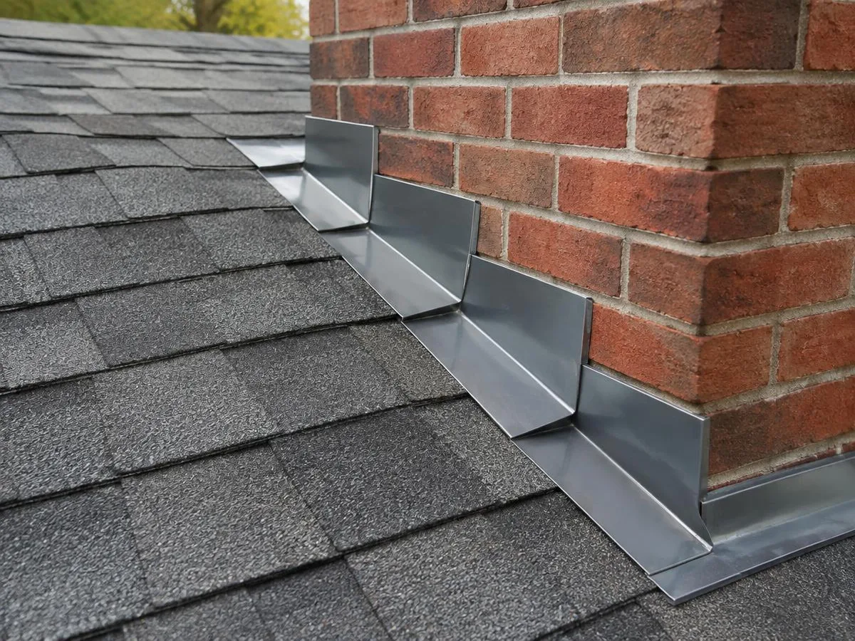New step flashing where a shingle roof meets a brick chimney