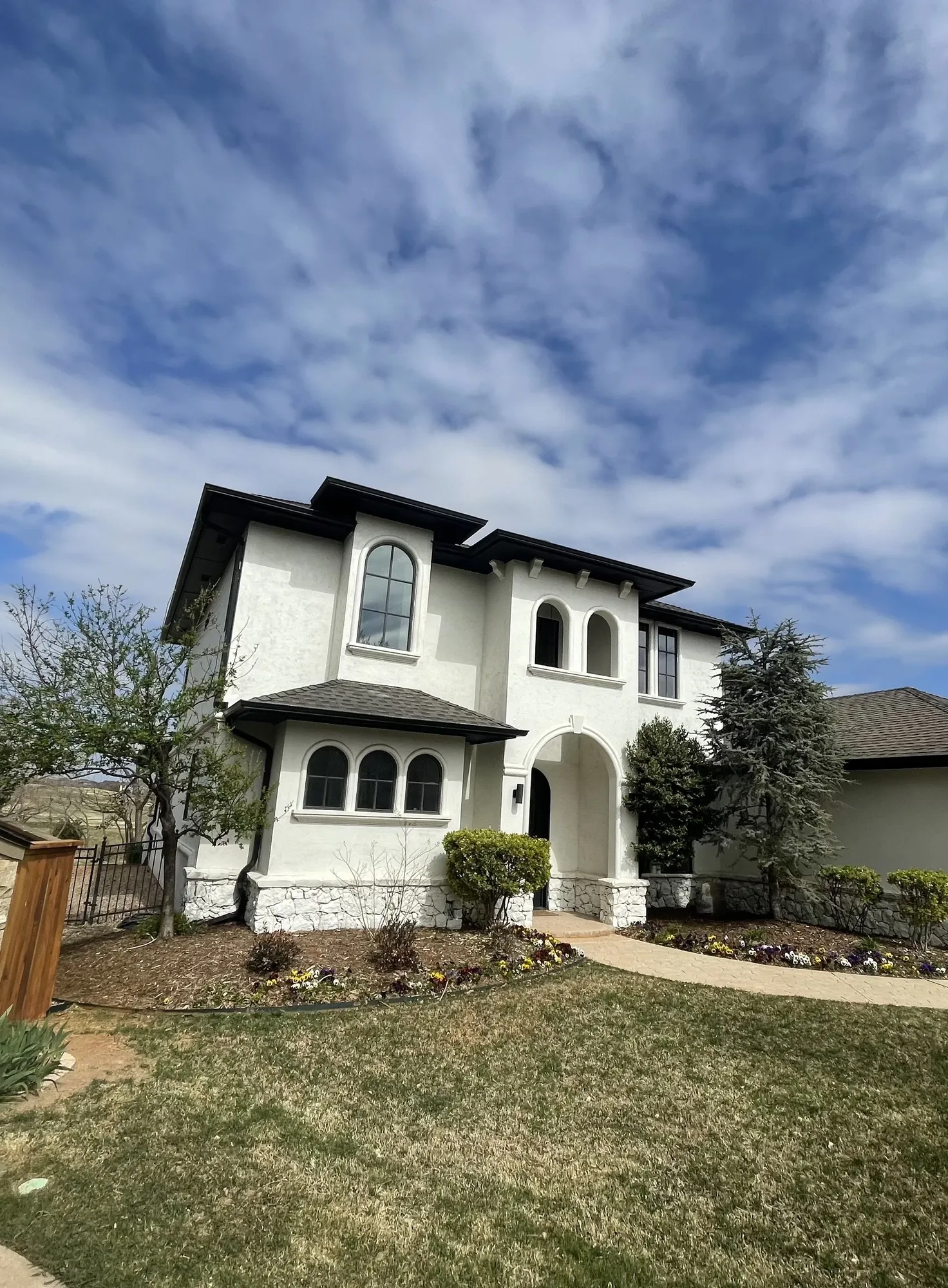 White two-story home with a new dark shingle roof
